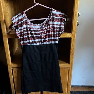A short dress with white red and black stripes and a black skirt